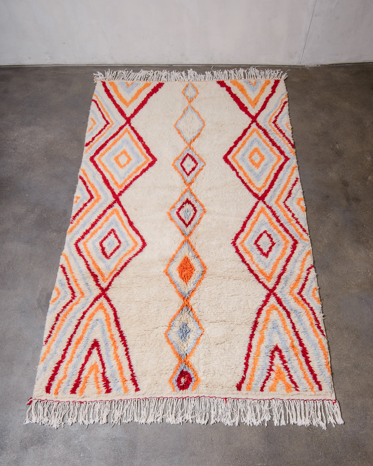 Berberlin Finest Rug made of plush wool laying flat on concrete floor.